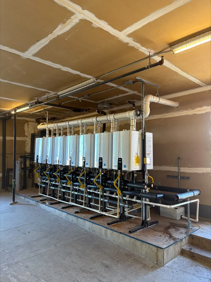 A commercial bank of tankless water heaters installed by Water Heater Man